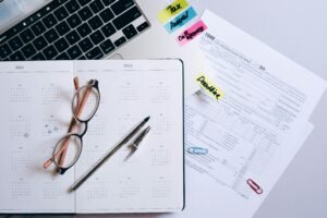 Organized workspace featuring a calendar, tax documents, and planner essentials.